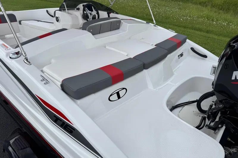 Slide: The Image of 2026 Tahoe T16 boat interior with red and gray seating, steering wheel, and motor. - 5