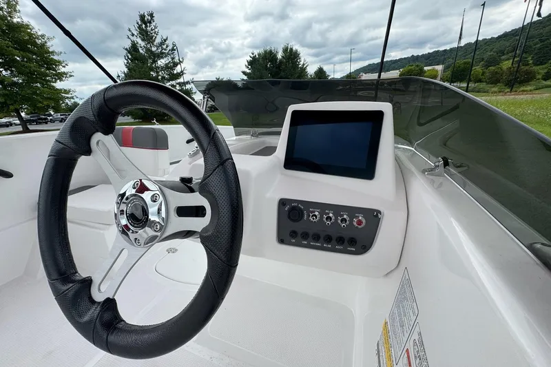 Slide: The Image of 2026 Tahoe T16 boat dashboard with steering wheel and control panel. - 6