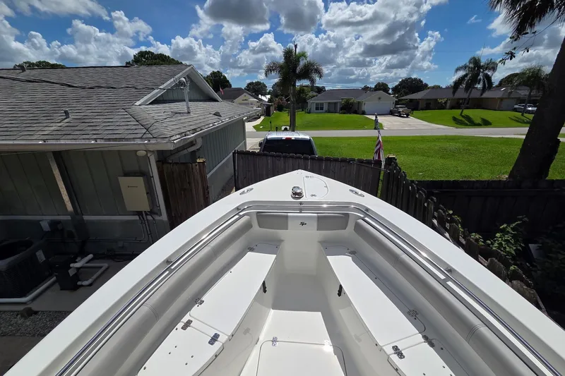 Slide: The Image of 2018 Sea Pro 219 Center Console boat docked in residential backyard under blue sky. - 10