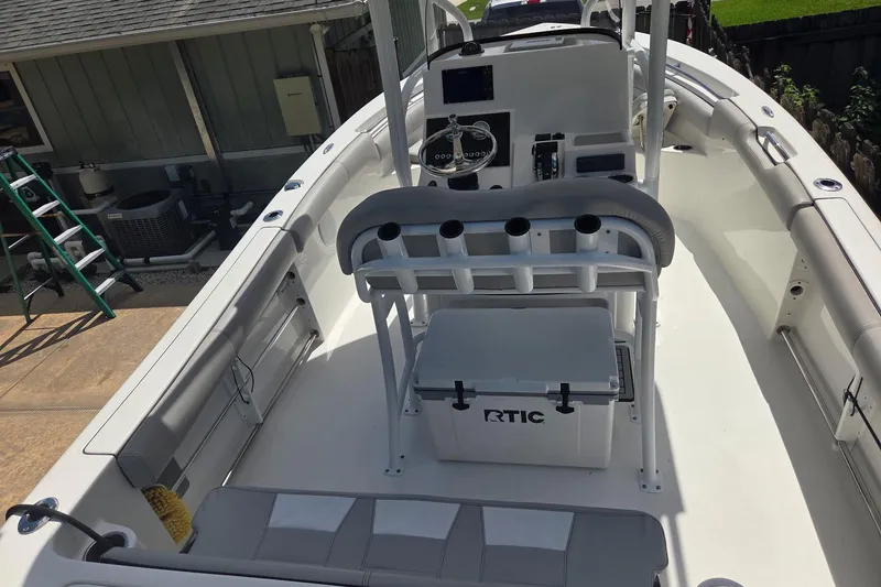 Slide: The Image of 2018 Sea Pro 219 Center Console boat with RTIC cooler and fishing rod holders. - 18