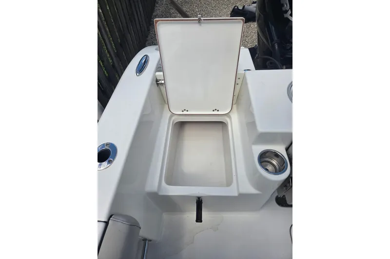 Slide: The Image of 2018 Sea Pro 219 Center Console boat storage compartment with open lid. - 21