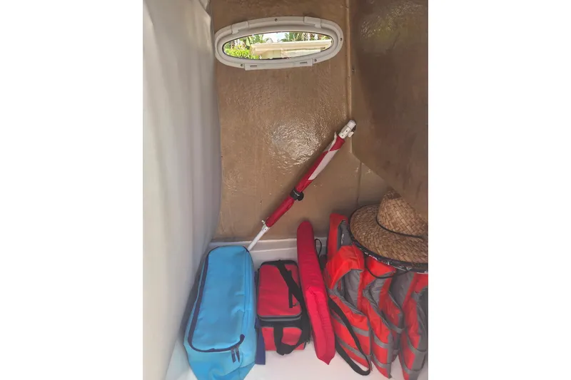 Slide: The Image of Interior storage of 2018 Sea Pro 219 Center Console with life jackets and gear. - 26