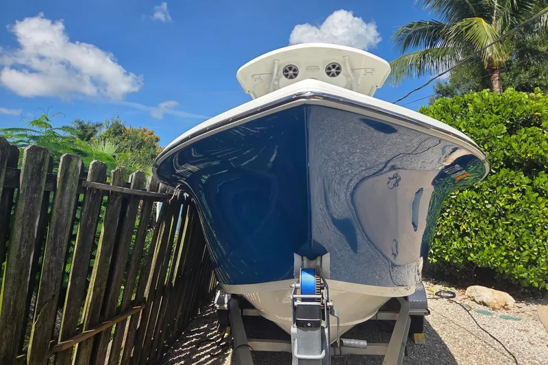 Slide: The Image of 2018 Sea Pro 219 Center Console boat on trailer, surrounded by lush greenery. - 3