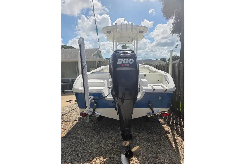 Slide: The Image of 2018 Sea Pro 219 Center Console boat with 200 Pro outboard motor, parked outdoors. - 7
