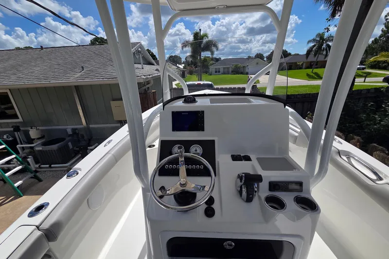 Slide: The Image of 2018 Sea Pro 219 Center Console boat interior with steering wheel and control panel. - 9