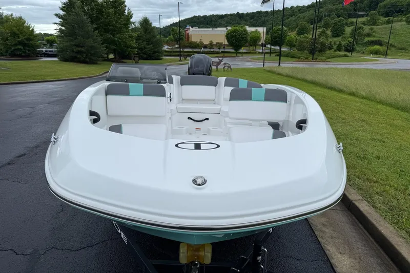 Slide: The Image of 2026 Tahoe T16 boat with sleek white design, parked outdoors on a cloudy day. - 7