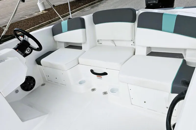 Slide: The Image of 2026 Tahoe T18 boat with Mercury Pro XS 115 outboard motor, parked on pavement. - 10