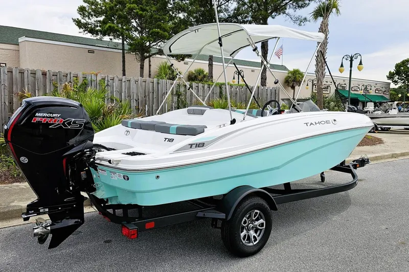 Slide: The Image of 2026 Tahoe T18 boat with Mercury Pro XS engine, parked on a trailer. - 2