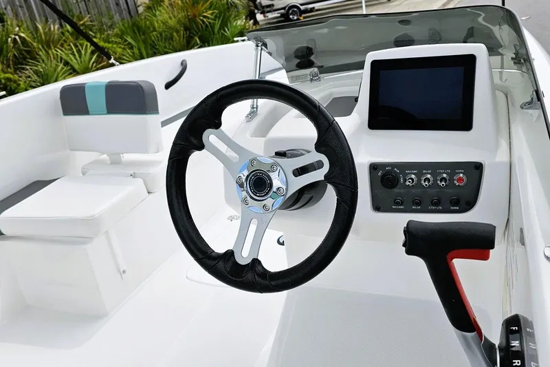 Slide: The Image of Interior of 2026 Tahoe T18 boat with white and teal seating arrangement. - 8