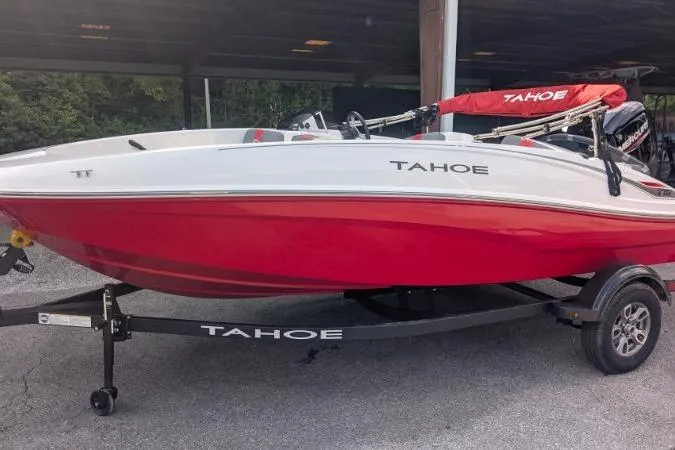 The Image of 2026 Tahoe T16 boat with red and white design on a trailer. - 0