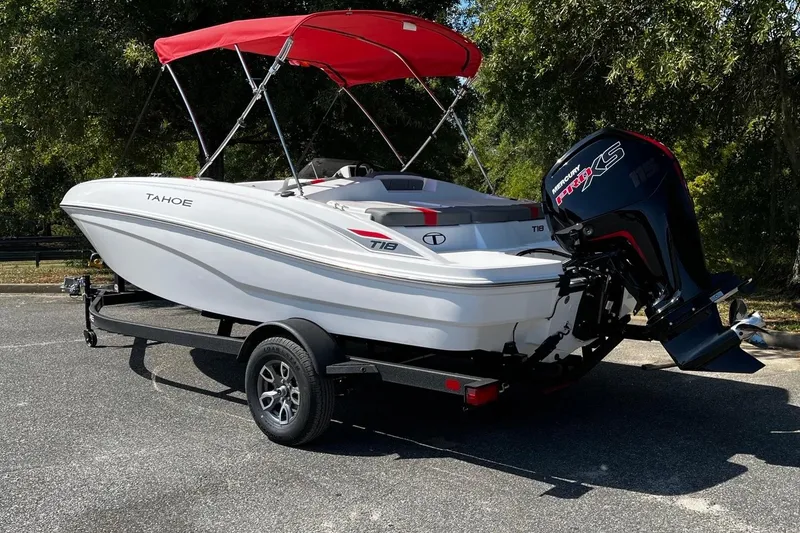Slide: The Image of 2026 Tahoe T18 boat with red canopy and Mercury engine on trailer. - 3