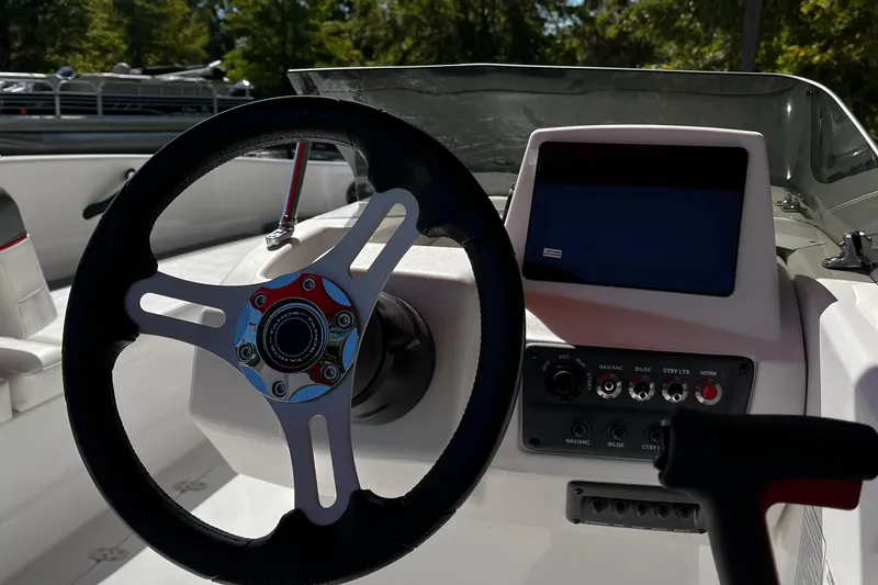 Slide: The Image of 2026 Tahoe T18 boat dashboard with steering wheel and control panel. - 6