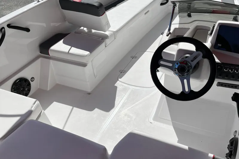 Slide: The Image of 2026 Tahoe T18 boat interior with steering wheel and seating area. - 8