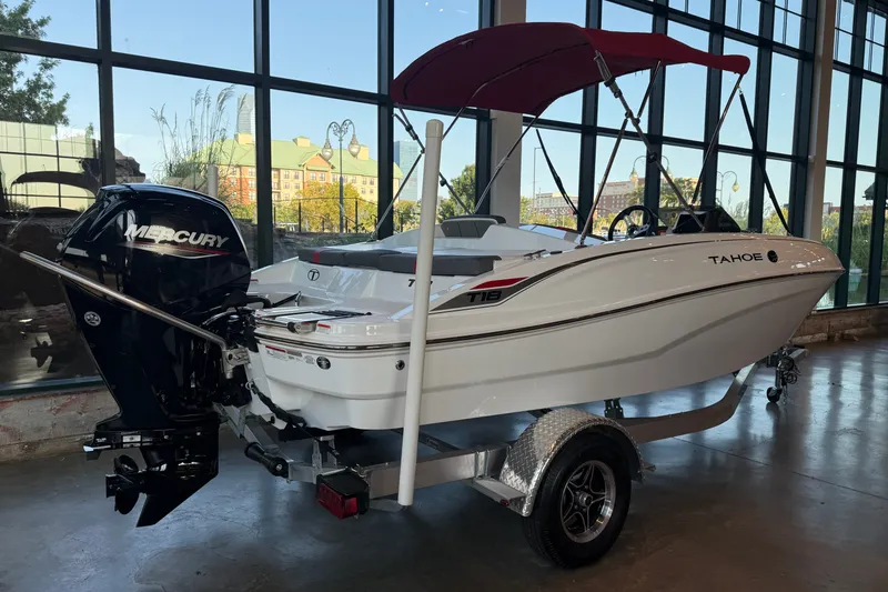 Slide: The Image of 2026 Tahoe T18 boat with Mercury engine displayed indoors. - 3