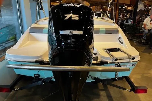 Slide: The Image of 2026 Tahoe T16 boat with Mercury 75 engine, displayed indoors. - 2