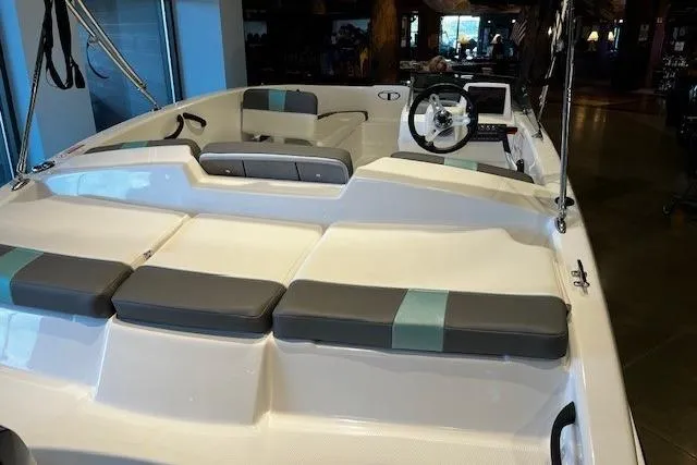 Slide: The Image of 2026 Tahoe T16 boat interior with seating and steering wheel in showroom. - 3