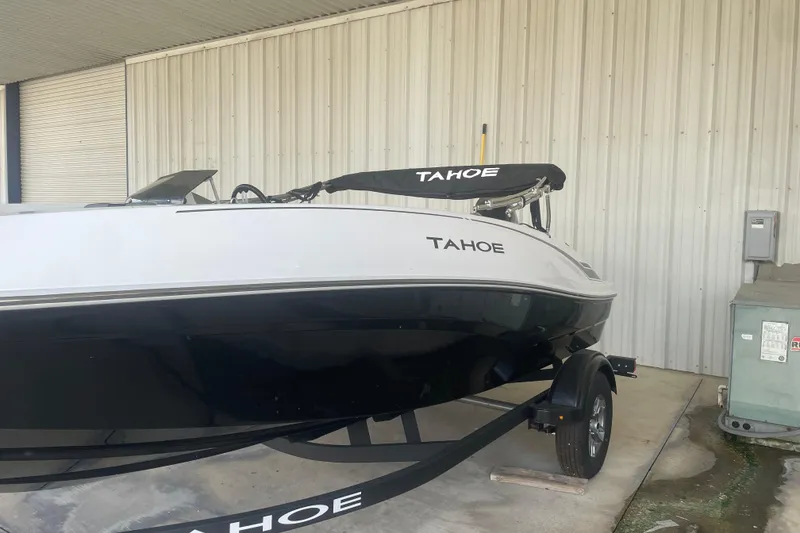 The Image of 2026 Tahoe T16 boat in storage, featuring sleek black and white design. - 0