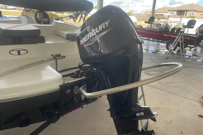 Slide: The Image of 2026 Tahoe T16 boat with Mercury outboard motor in a garage setting. - 2