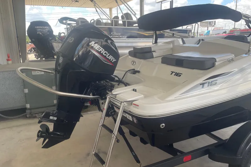Slide: The Image of 2026 Tahoe T16 boat with Mercury outboard motor, displayed in a showroom. - 3