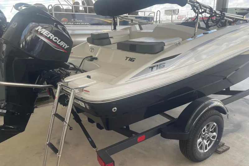 Slide: The Image of 2026 Tahoe T16 boat with Mercury engine on trailer, featuring sleek design and modern features. - 4