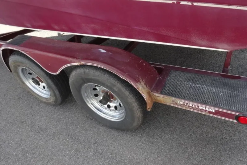 Slide: The Image of Red Caravelle 206 trailer, dual wheels, visible rust, parked on asphalt, 1995 model. - 12