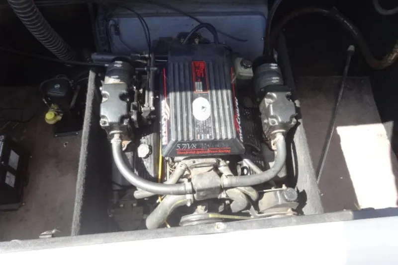 Slide: The Image of Engine compartment of a 1995 Caravelle 206 boat, featuring a 5.7L V8 engine. - 13