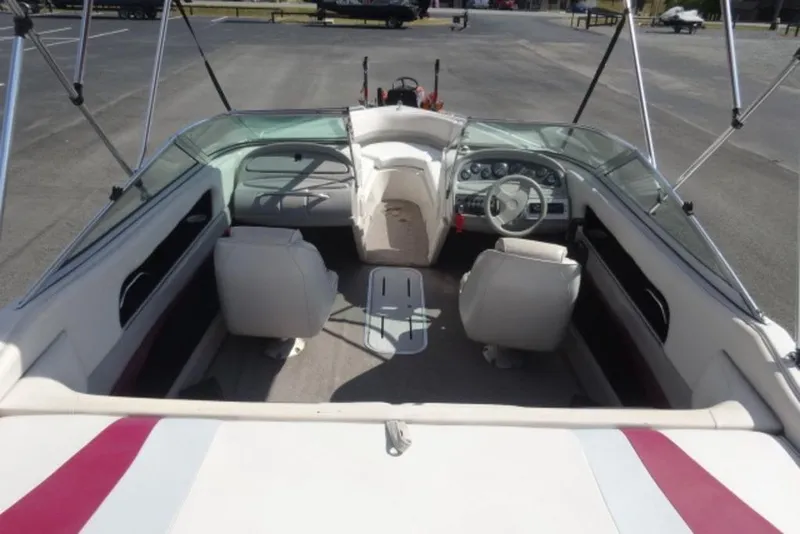 Slide: The Image of Interior of a 1995 Caravelle 206 boat with white seating and dashboard. - 2