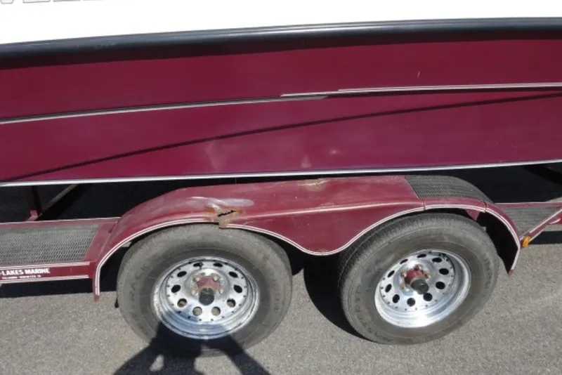 Slide: The Image of Trailer with maroon Caravelle 206 boat, dual wheels, 1995 model. - 9