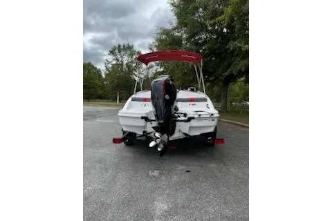 Slide: The Image of 2026 Tahoe T18 boat with outboard motor, parked outdoors on a cloudy day. - 3