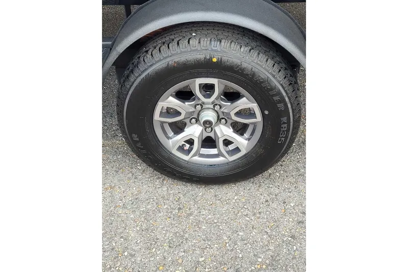 Slide: The Image of 2026 Tahoe T18 trailer wheel with Karrier KR35 tire on asphalt. - 7