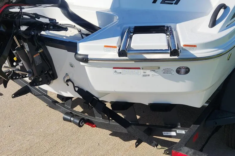 Slide: The Image of 2026 Tahoe T21 boat rear view with motor and trailer, showcasing sleek design. - 4