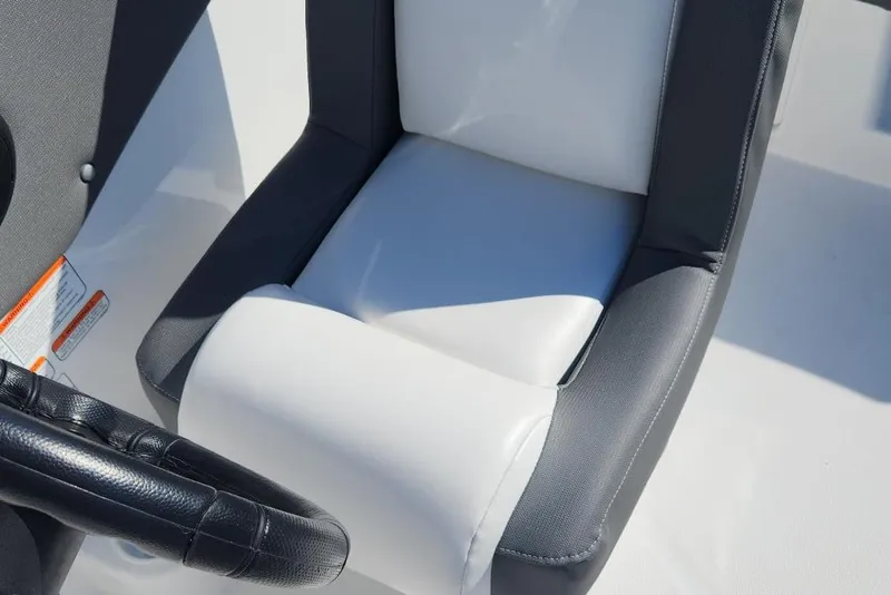Slide: The Image of 2026 Tahoe T21 boat seat with black and white upholstery, featuring a steering wheel. - 5