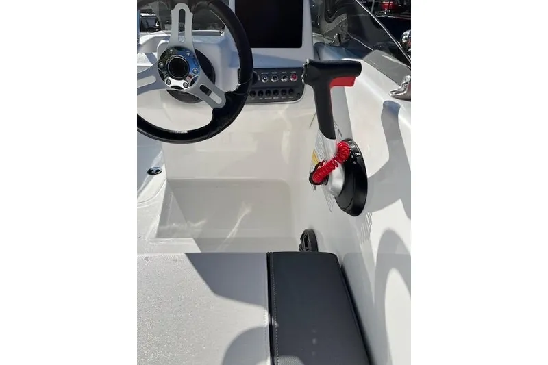 Slide: The Image of Interior of 2026 Tahoe T16 boat showing steering wheel and control panel. - 2