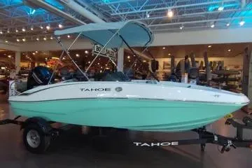 Slide: The Image of 2026 Tahoe T16 boat with canopy displayed indoors. - 65
