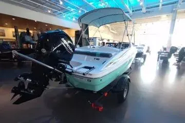Slide: The Image of 2026 Tahoe T16 boat in showroom with outboard motor and canopy. - 66