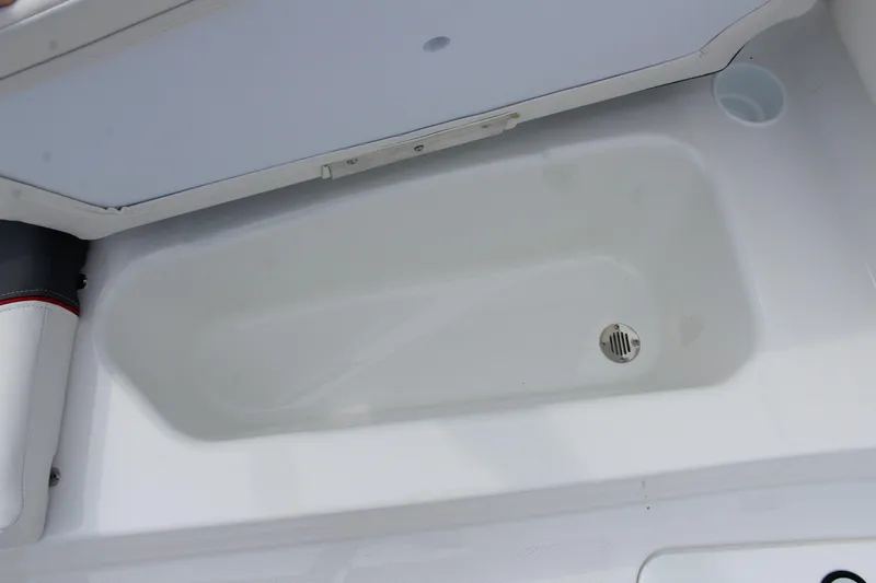 Slide: The Image of 2026 Tahoe T16 boat storage compartment with drain, featuring white interior design. - 17