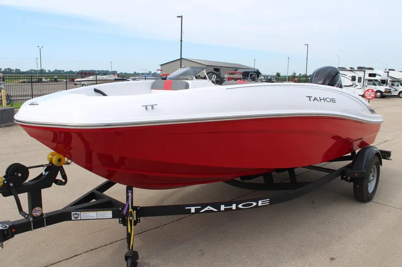 Slide: The Image of 2026 Tahoe T16 boat with red hull on trailer, parked outdoors. - 3
