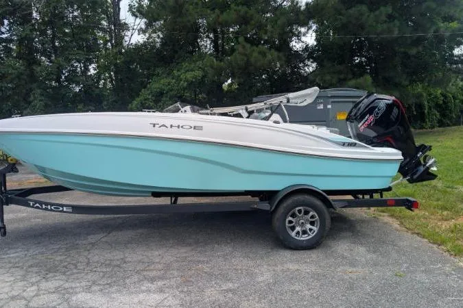 The Image of 2026 Tahoe T18 boat on trailer, light blue hull, parked outdoors. - 0