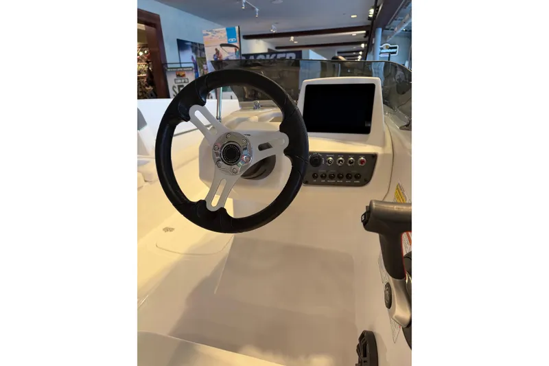 Slide: The Image of 2026 Tahoe T16 boat dashboard with steering wheel and control panel. - 2