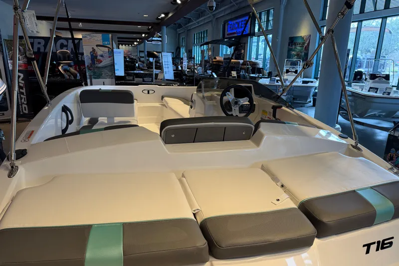 Slide: The Image of 2026 Tahoe T16 boat interior with seating and steering wheel in showroom. - 3