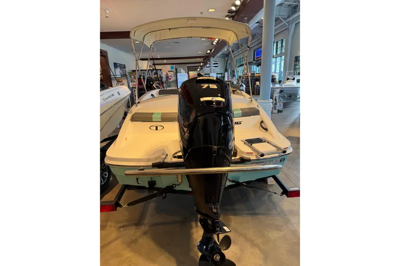 Slide: The Image of 2026 Tahoe T16 boat with Mercury 75 engine displayed indoors. - 5