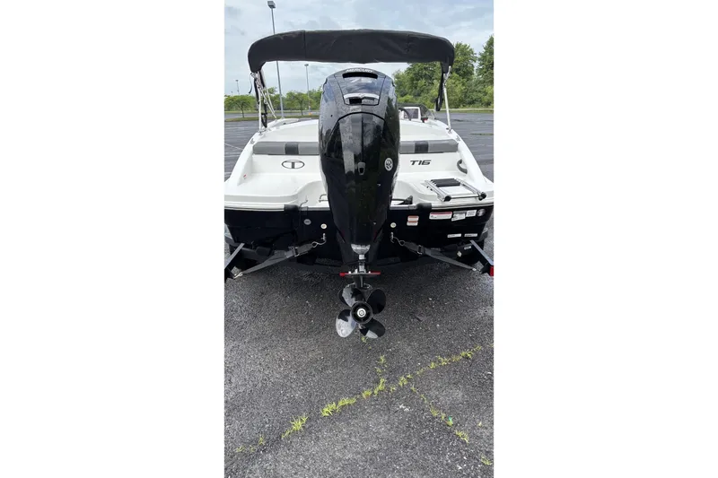 Slide: The Image of 2026 Tahoe T16 boat with outboard motor, parked on asphalt. - 3