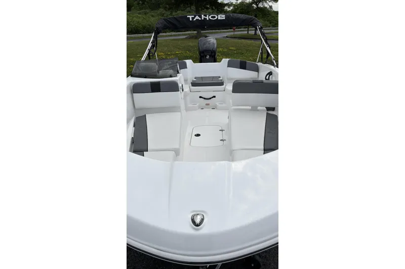 Slide: The Image of 2026 Tahoe T16 boat interior with seating and storage, featuring sleek white and gray design. - 2