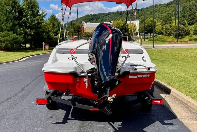 Slide: The Image of 2026 Tahoe T18 boat with outboard motor on a trailer, parked outdoors. - 3