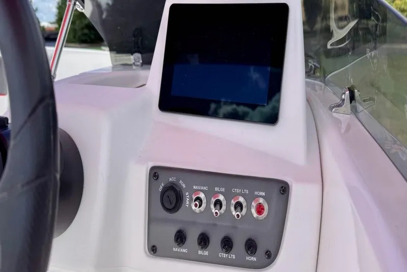 Slide: The Image of 2026 Tahoe T18 boat dashboard with control panel and touchscreen display. - 5