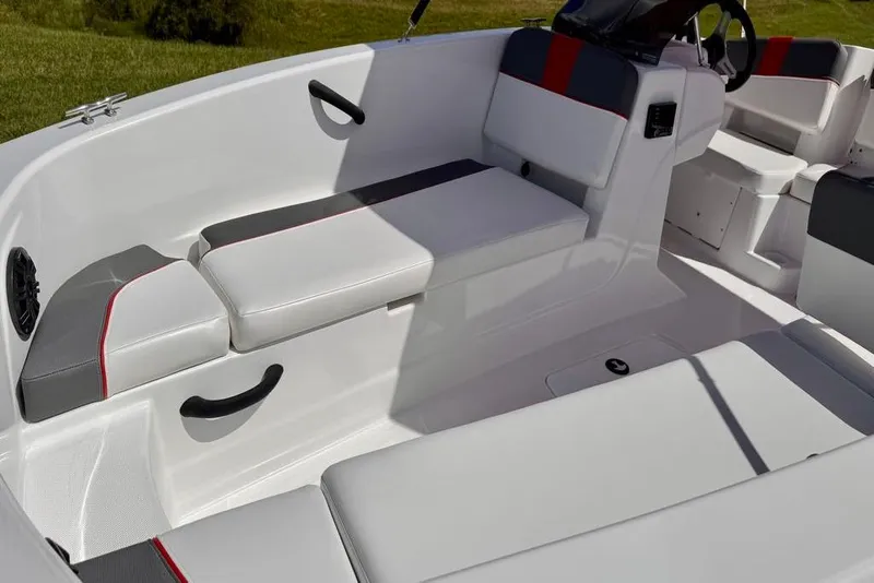 Slide: The Image of 2026 Tahoe T18 boat interior with white and gray seating, red accents, and steering wheel. - 6