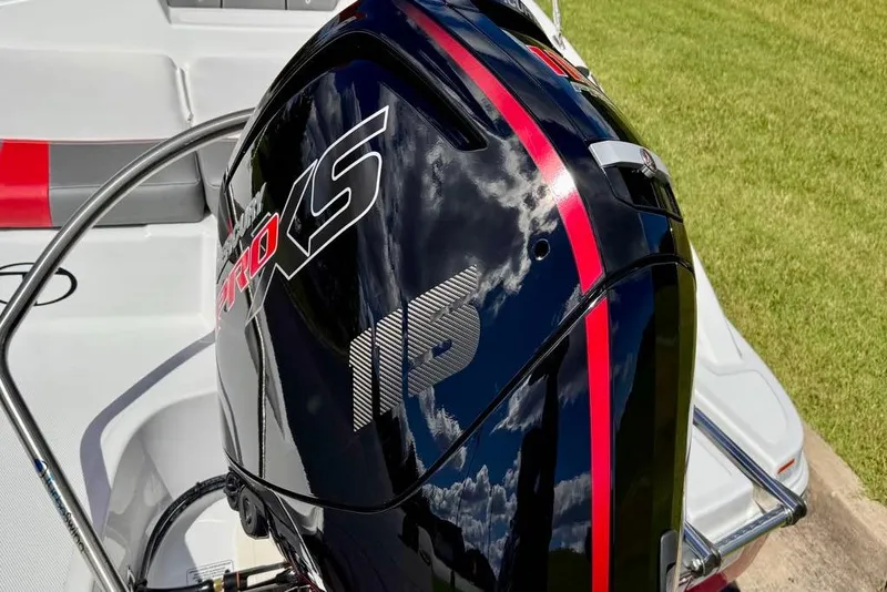 Slide: The Image of 2026 Tahoe T18 boat with a sleek black and red outboard motor, reflecting clouds. - 8