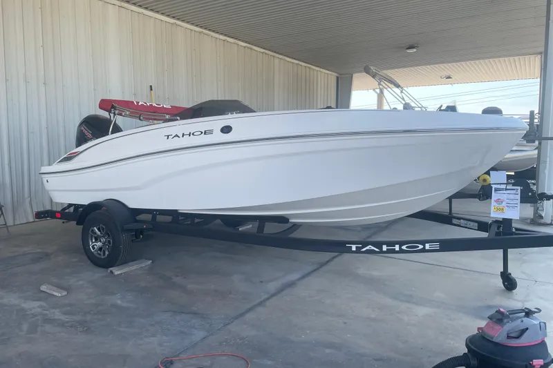 The Image of 2026 Tahoe T18 boat on trailer in showroom, side view. - 0