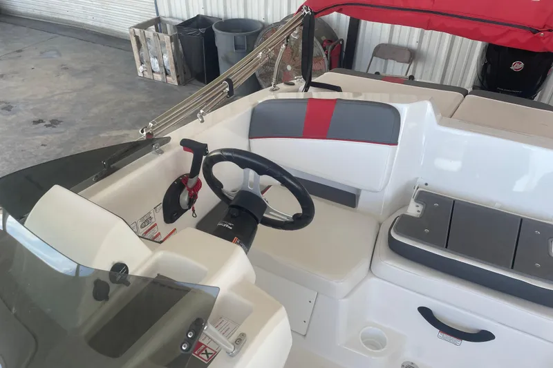 Slide: The Image of 2026 Tahoe T18 boat interior with steering wheel and seating, featuring red and gray accents. - 10