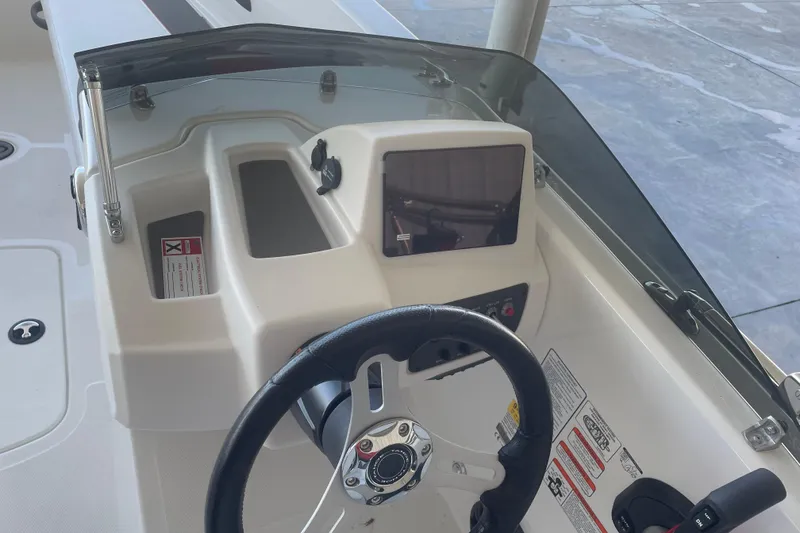 Slide: The Image of 2026 Tahoe T18 boat dashboard with steering wheel and control panel. - 11